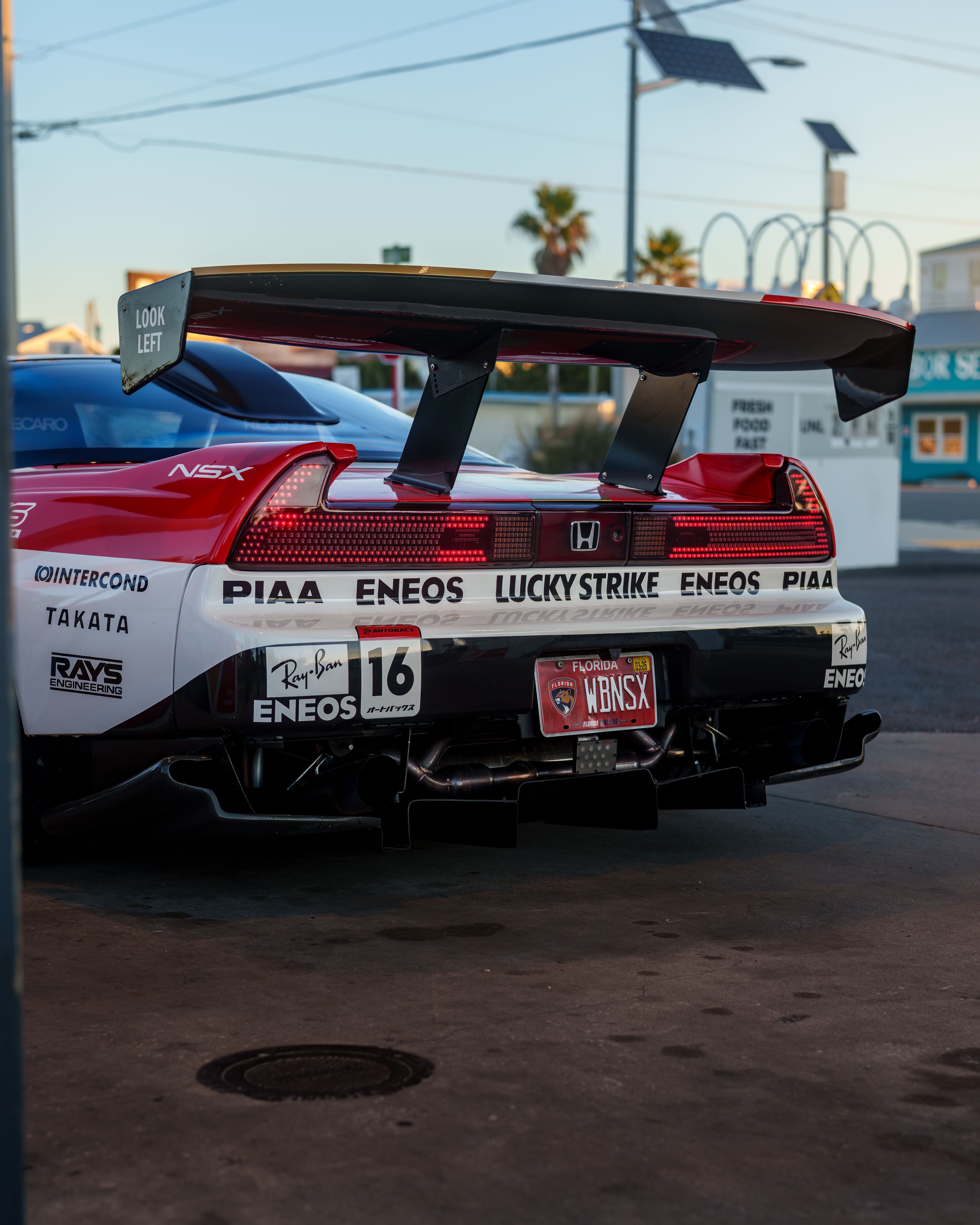 Rear View of Modified Performance Car at Gas Station · Free Stock Photo