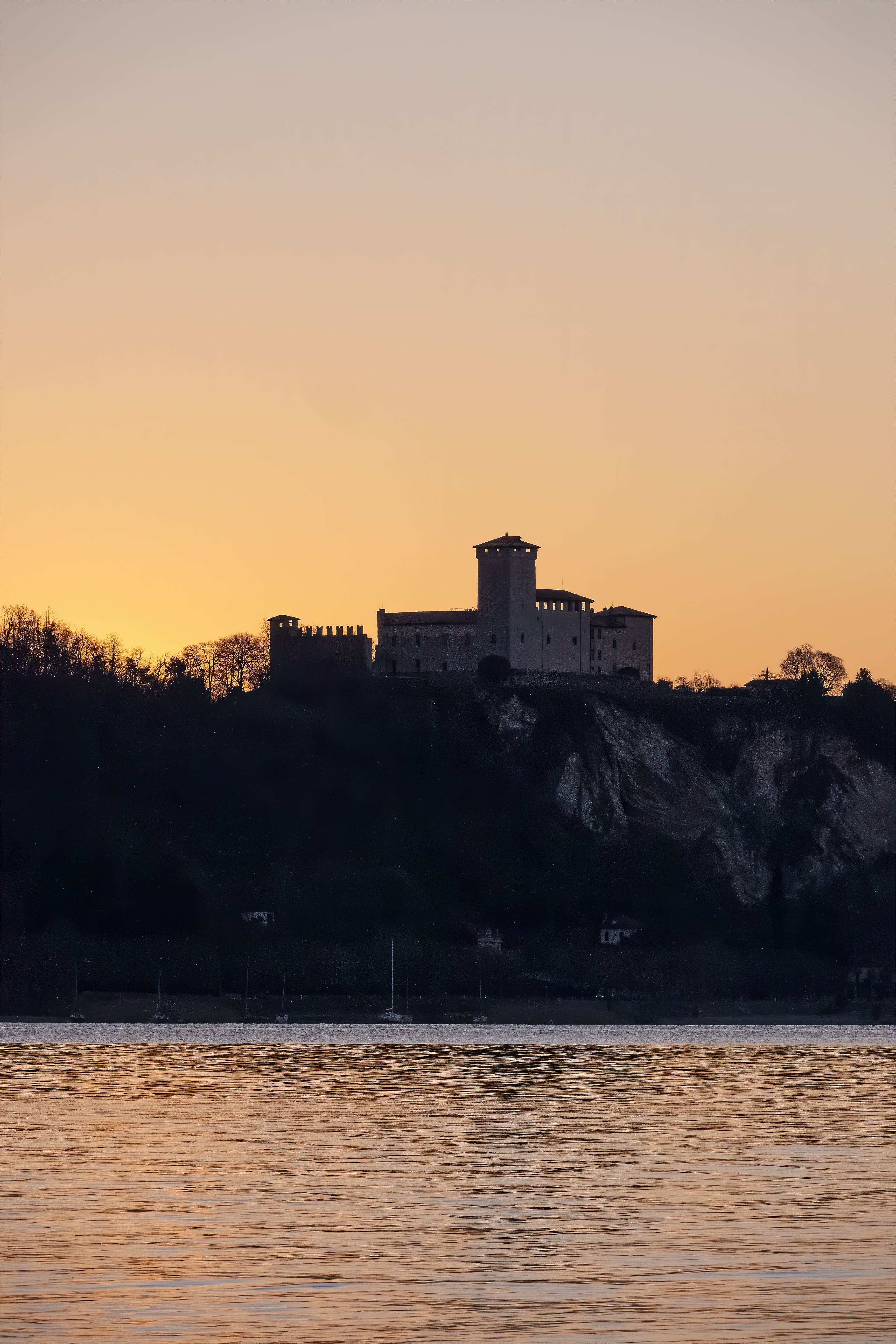 Silhouette of Castle at Sunset Over Tranquil Lake · Free Stock Photo