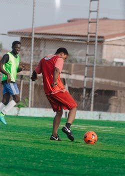 Teenage boys playing soccer on an outdoor field, enjoying a vibrant game.