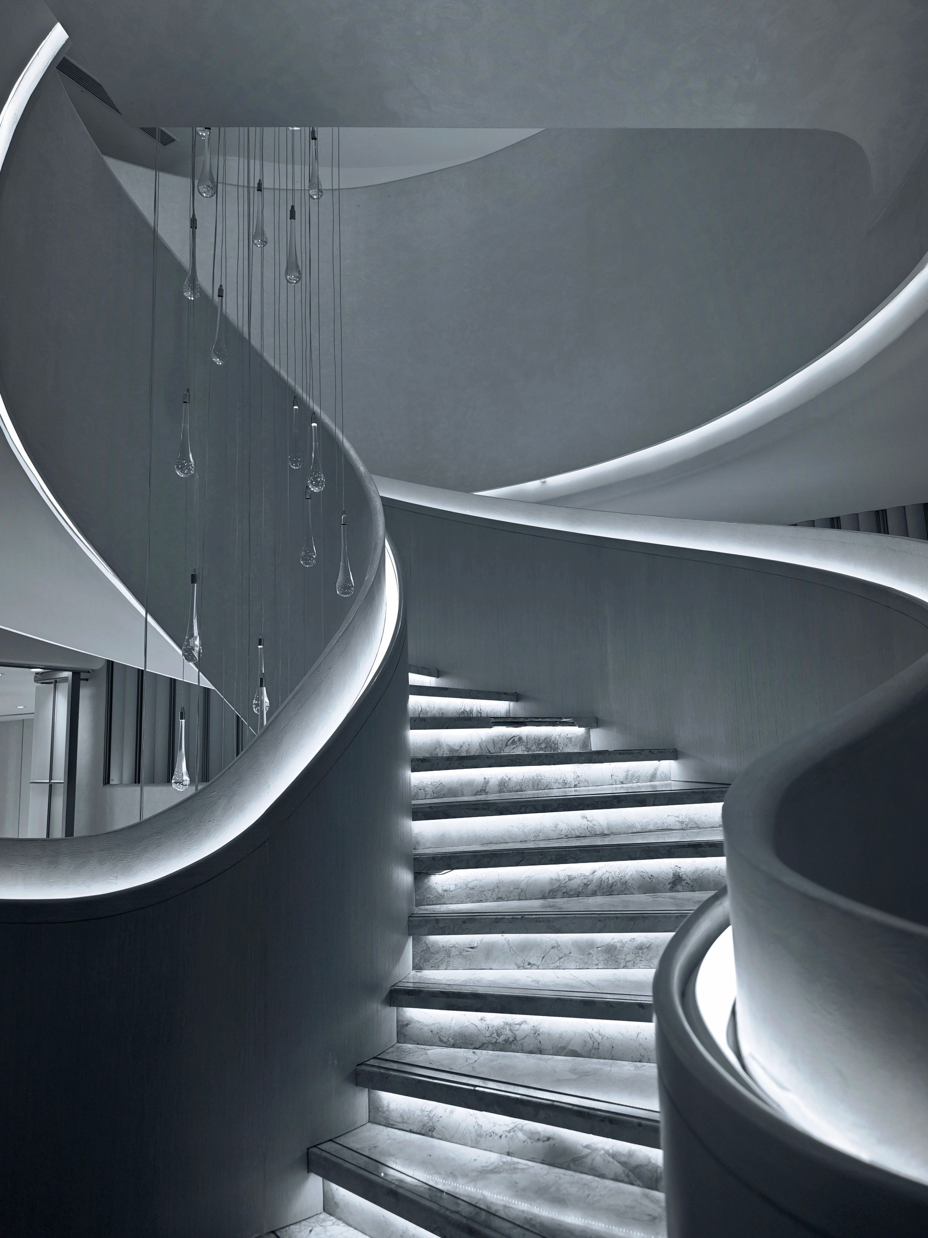 Modern luxury staircase with floating steps and dramatic lighting