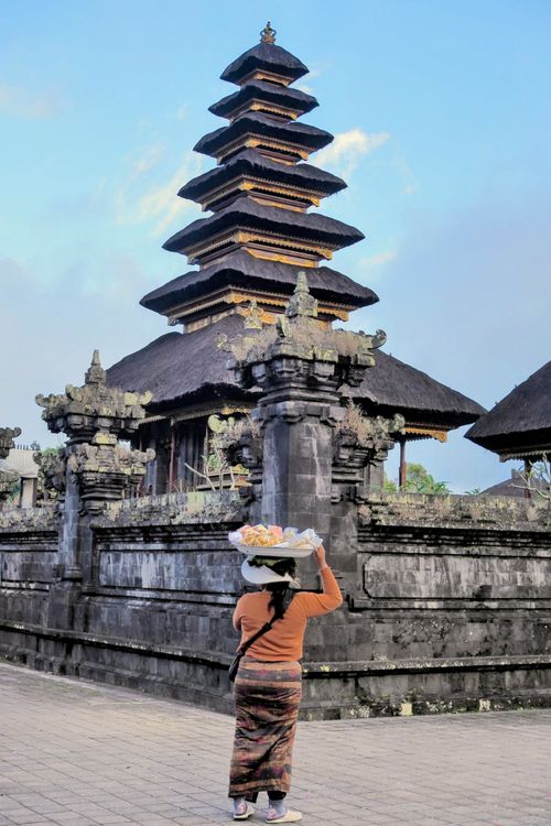 Free A woman carrying a tray outside the historic Besakih Temple in Bali, Indonesia. Stock Photo