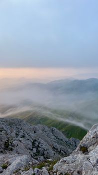 Peaceful foggy mountain view at dawn, capturing serene nature.