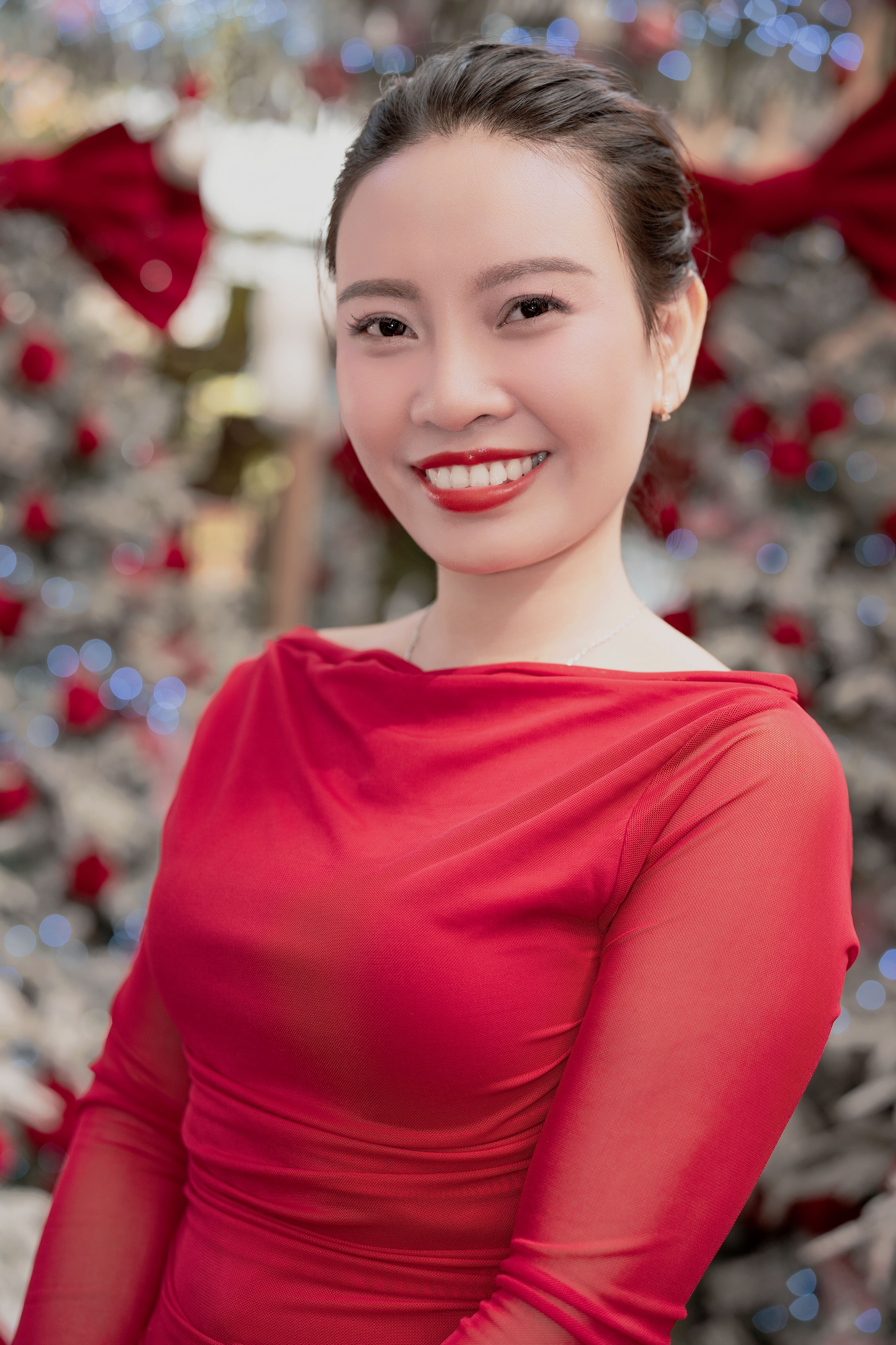 Woman Smiling in Festive Red Dress at Holiday Event · Free Stock Photo