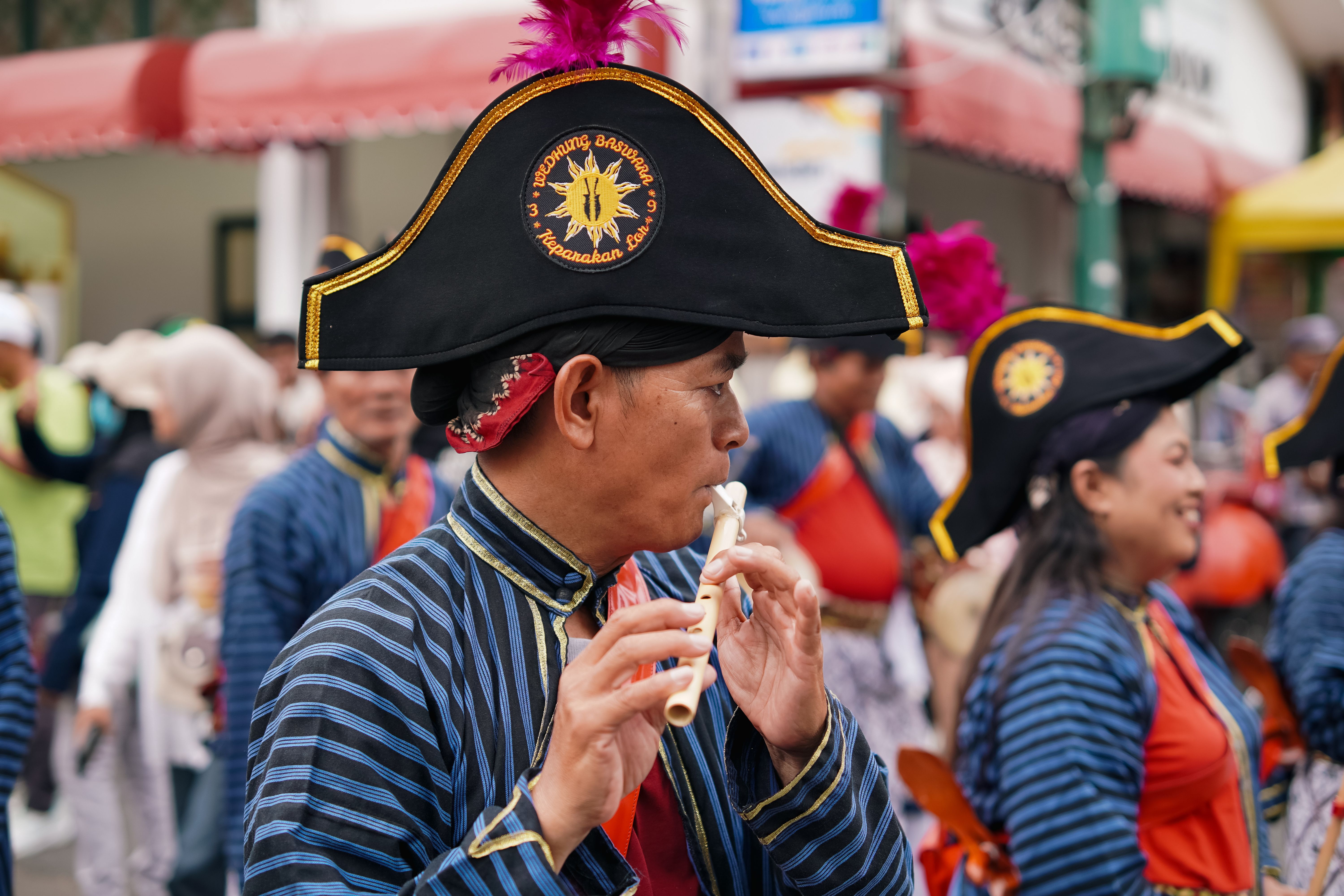 Vibrant parade with traditional attire in Yogyakarta, Indonesia, showcasing cultural heritage.