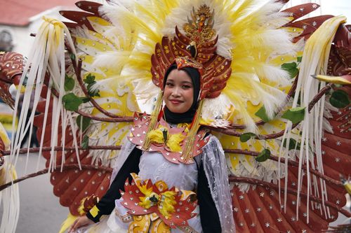 Free Colorful cultural parade in Yogyakarta featuring traditional vibrant costumes and joyous celebration. Stock Photo