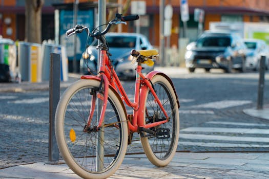 Red bike locked on a city street in Olhão, Portugal on a sunny day.