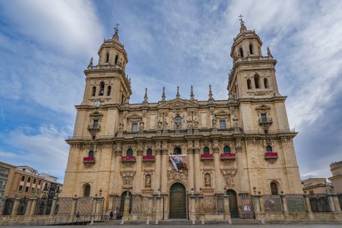 Free Front view of Jaén Cathedral, a historic landmark in Spain under a dramatic sky. Stock Photo