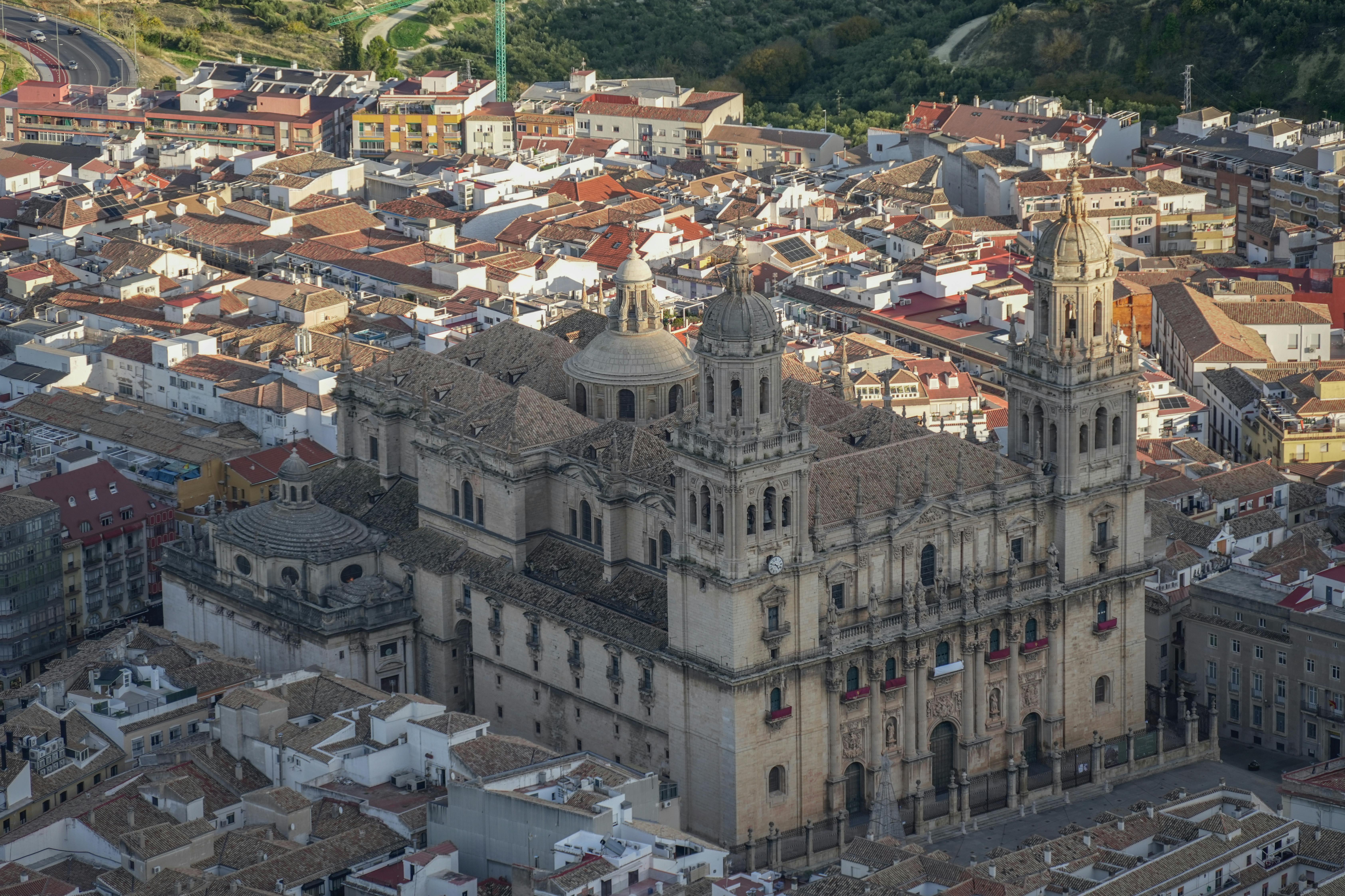 Breathtaking aerial view of the historic Jaén Cathedral surrounded by the vibrant cityscape of Andalucía, Spain.