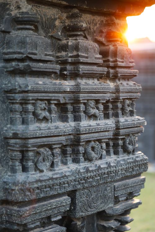 Free Detailed stone carving on a historic temple with warm sunrise light Stock Photo