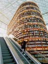 未来派图书馆内部，高耸的书架和玻璃天花板下的自动扶梯引人注目