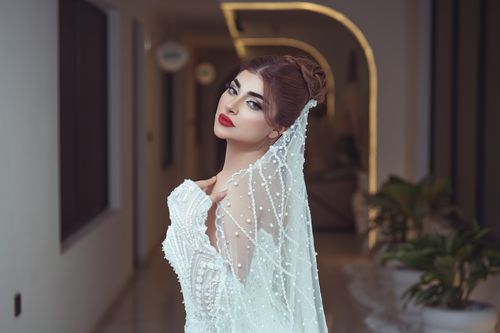 Free Stunning portrait of a bride in a white gown with pearl veil. Stock Photo