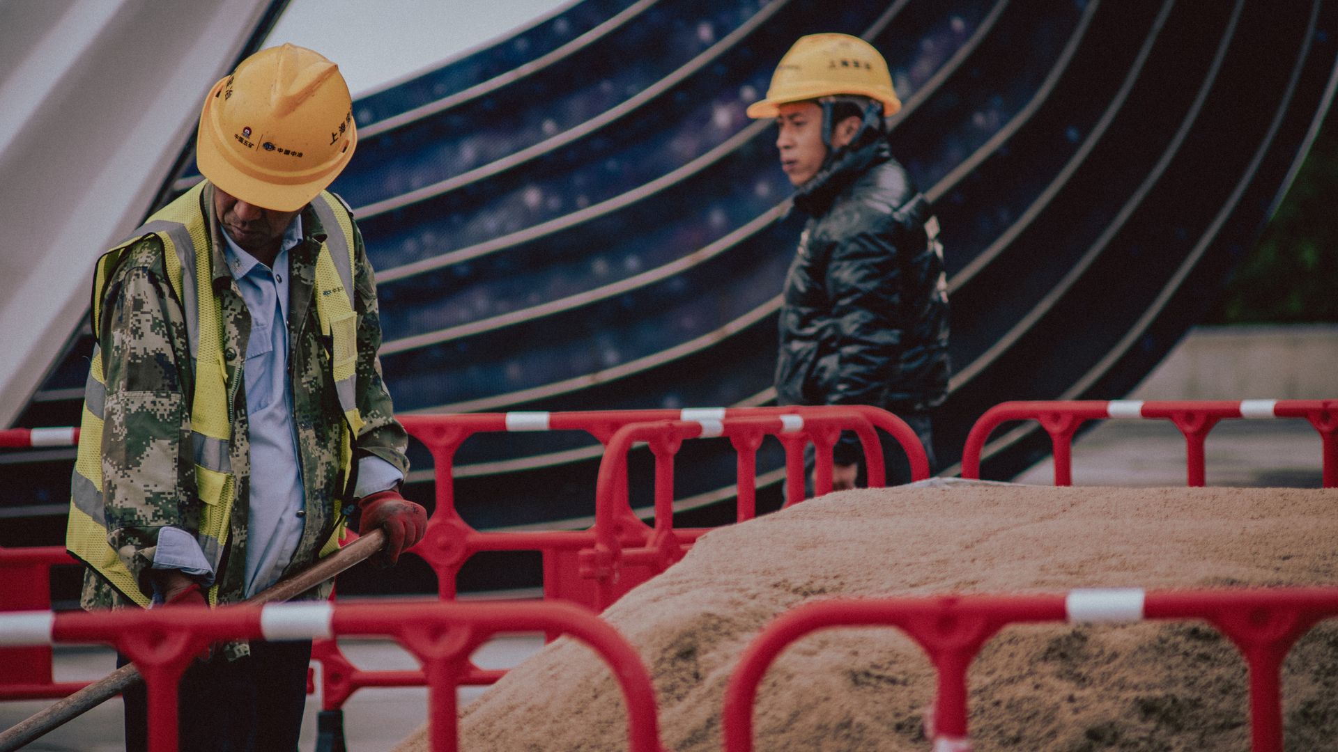 Modafinil for Night Shift Workers: Enhancing Productivity Construction workers with safety gear managing a sand pile outdoors on an urban site — modafinil for night shift workers