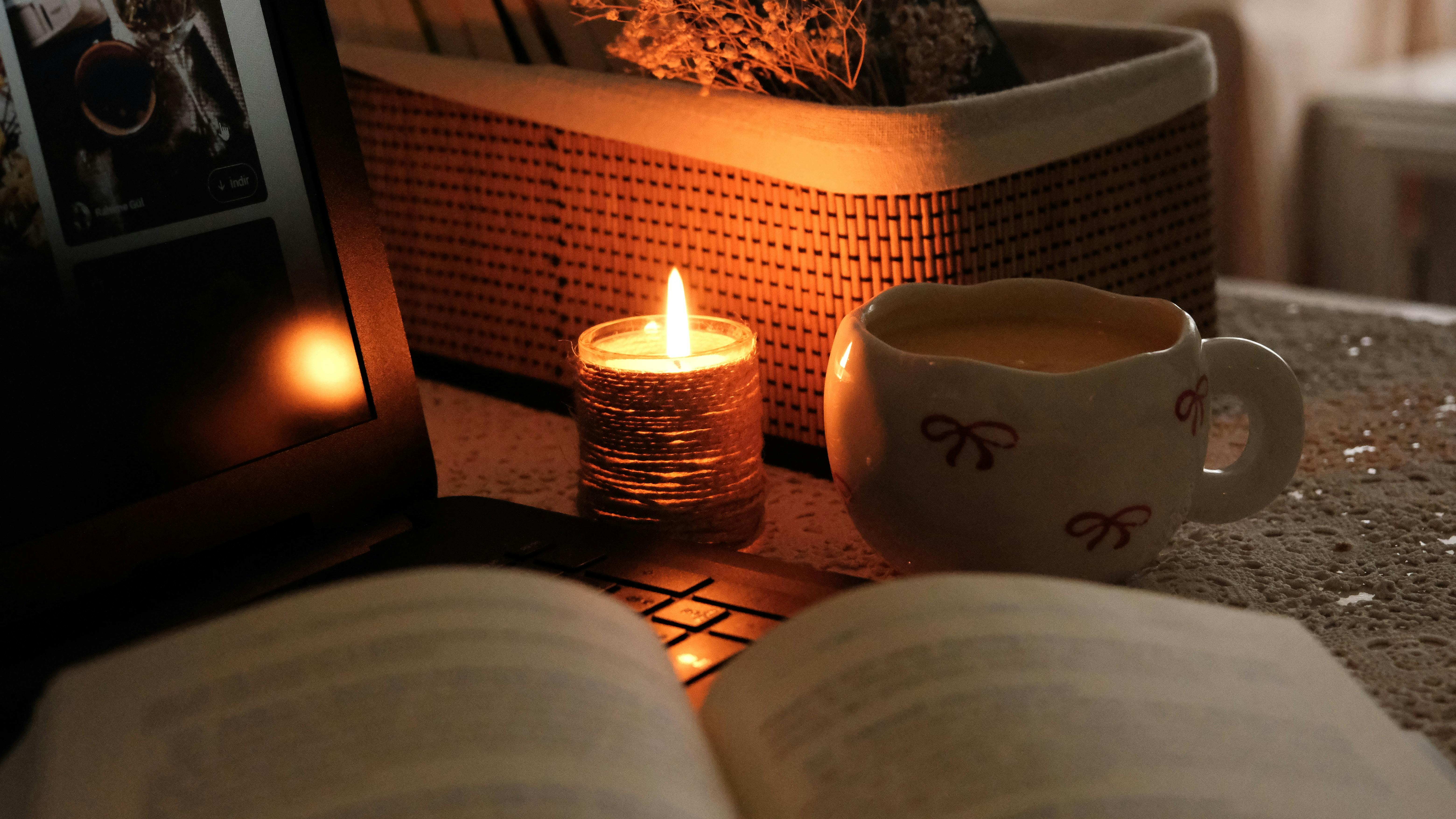 Cozy Evening Setup with Candlelight and Book · Free Stock Photo