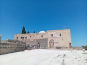 Explore the historic ruins of Umm Qais under a clear blue sky in the Irbid Governorate, Jordan.