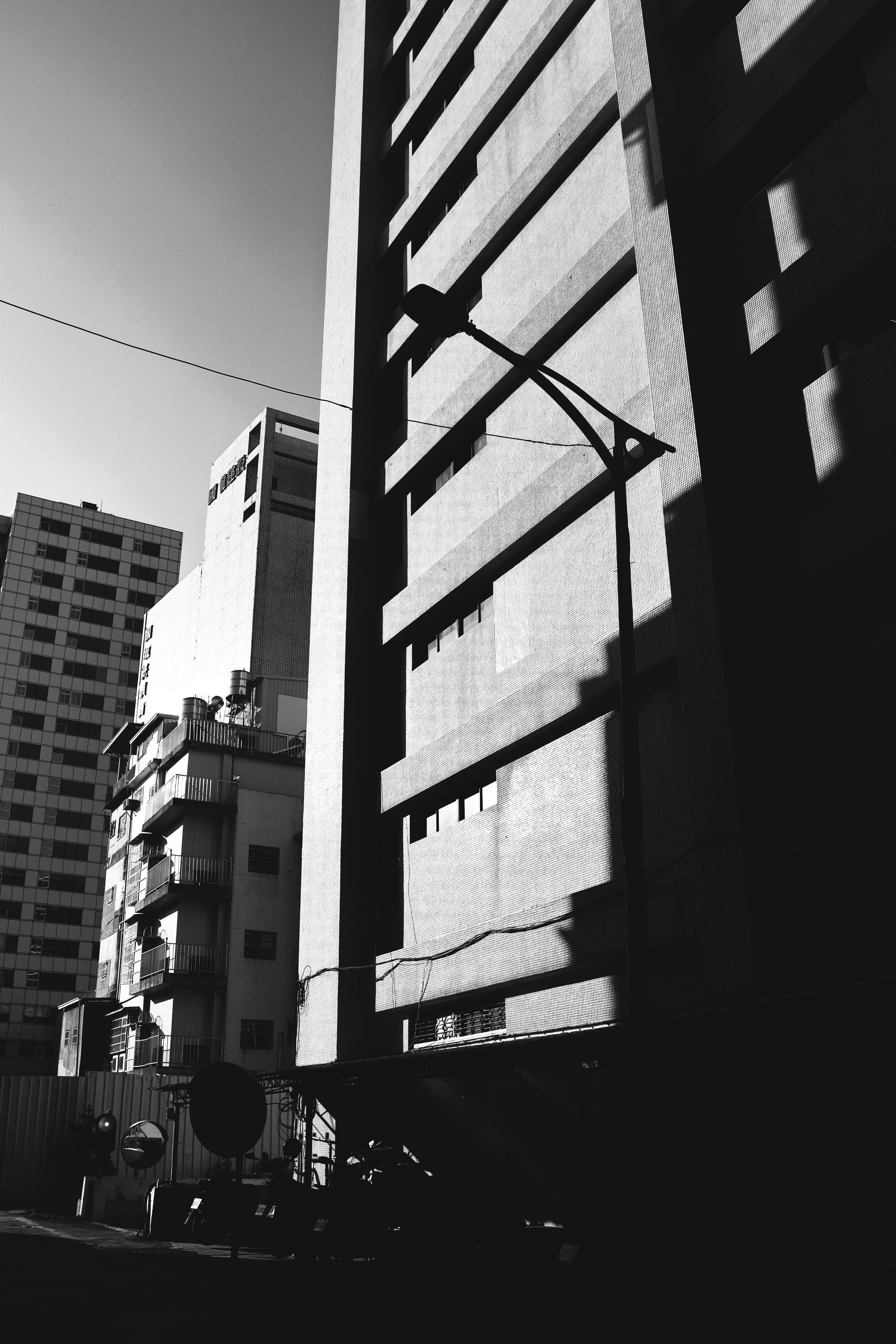 Dramatic Shadows on Urban Buildings in Black and White · Free Stock Photo
