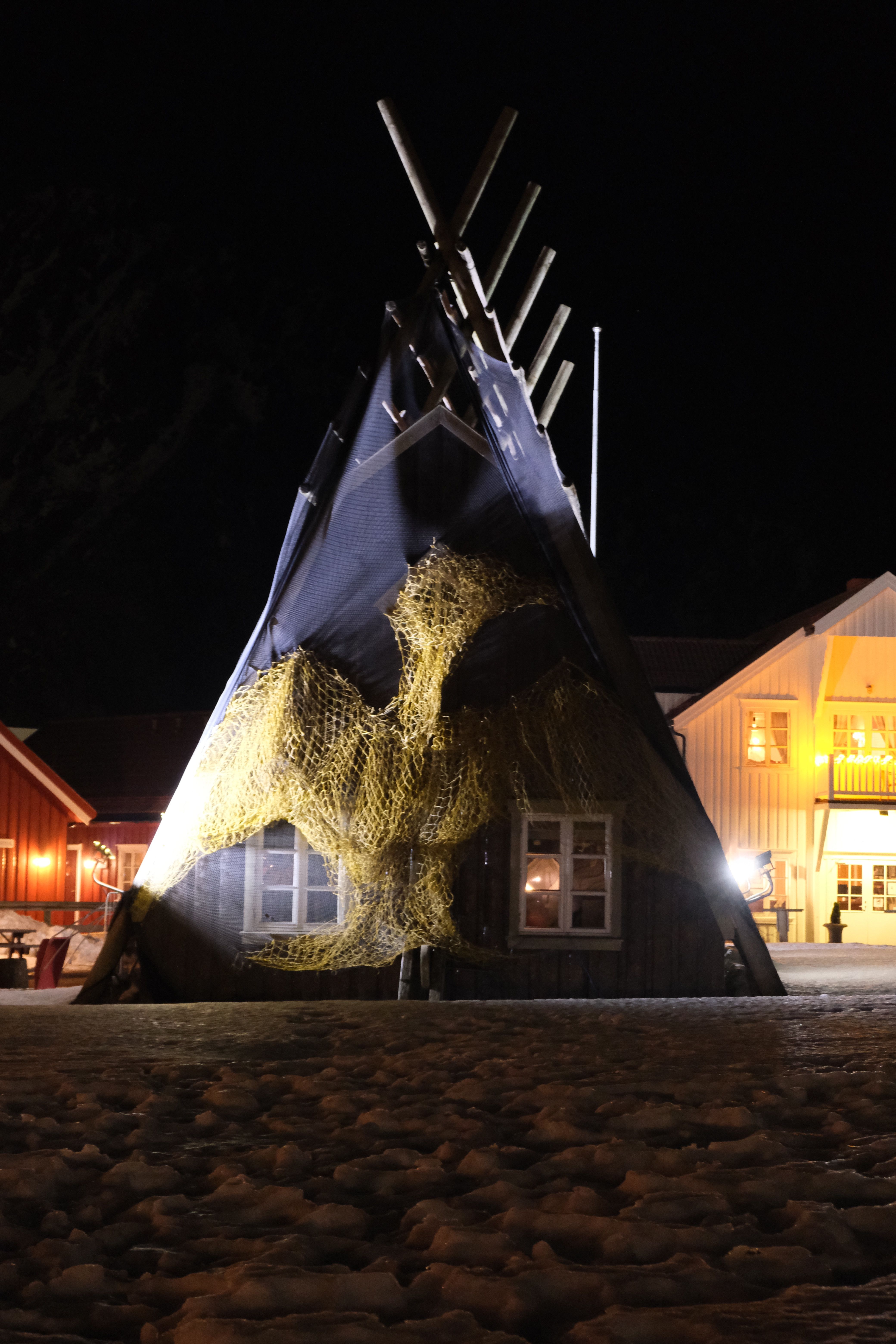Illuminated Night Scene of Wooden A-Frame Structure · Free Stock Photo
