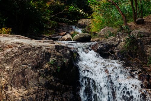 Free Beautiful waterfall flowing over rocks in a lush jungle setting, Kon Tum, Vietnam. Stock Photo