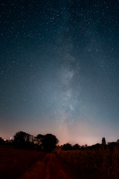 Gorgeous night sky view of the Milky Way over a rural landscape in France.