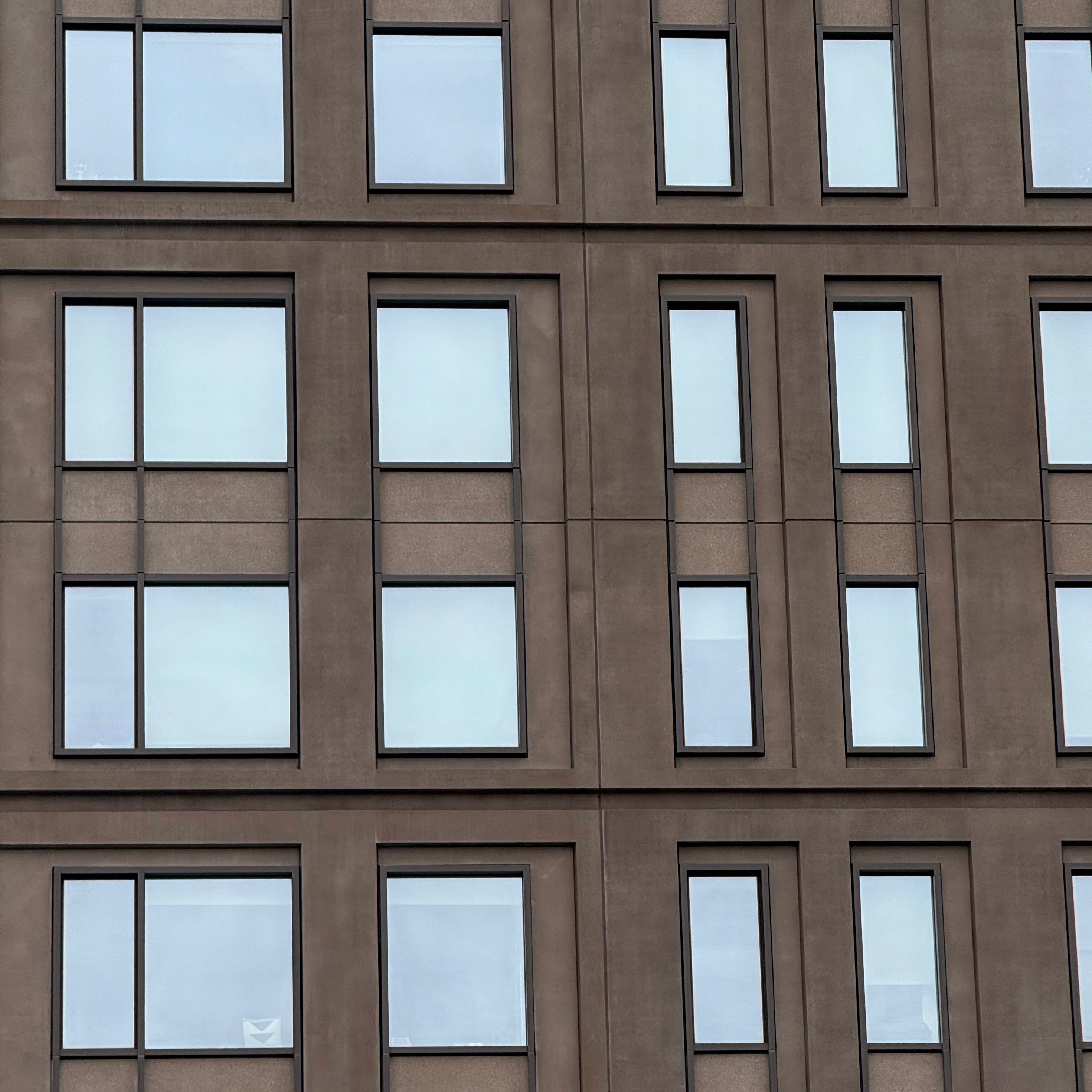 Modern Building Facade with Symmetrical Windows · Free Stock Photo