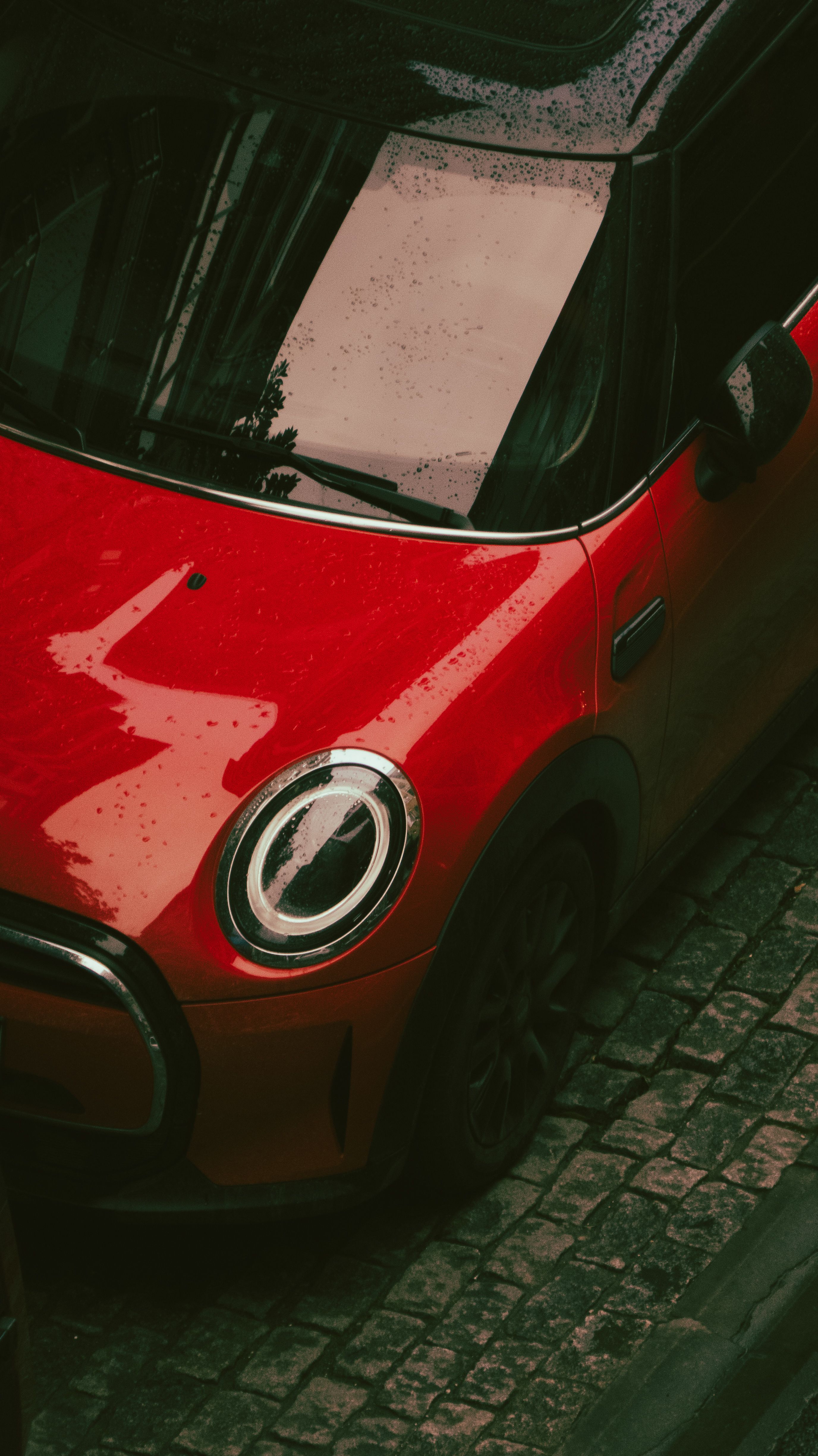 Red Urban Car on Cobbled Street Top View · Free Stock Photo
