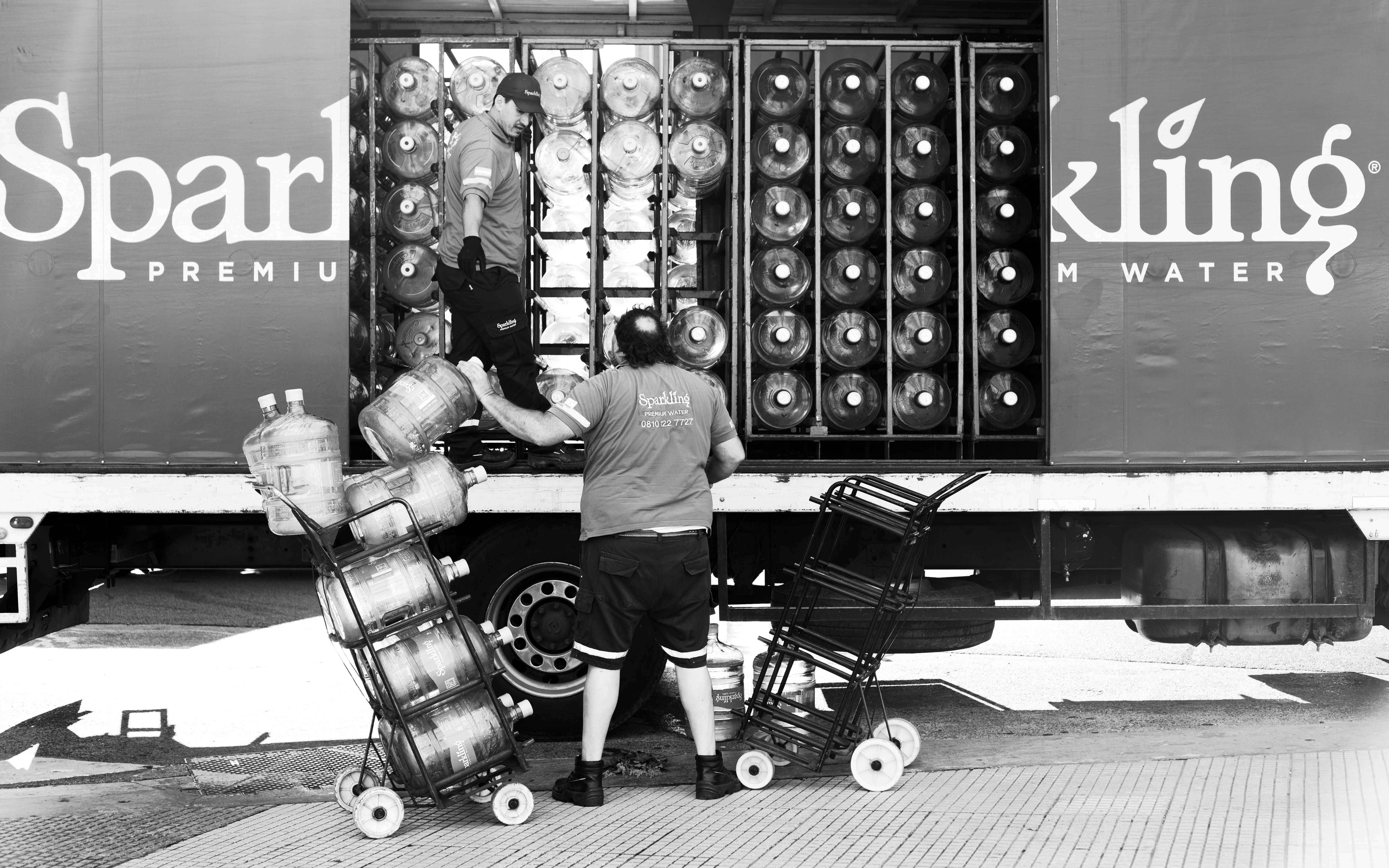 Men unloading water bottles from a truck in Buenos Aires, Argentina.