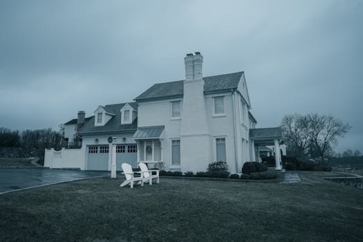 A classic white house on a cloudy day, perfect for real estate or architectural themes.