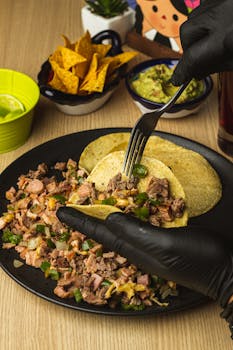 Delicious Mexican street tacos with beef, lime, and guacamole, perfect for a festive setting.