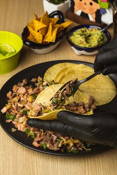 Delicious Mexican street tacos with beef, served with guacamole and tortilla chips.