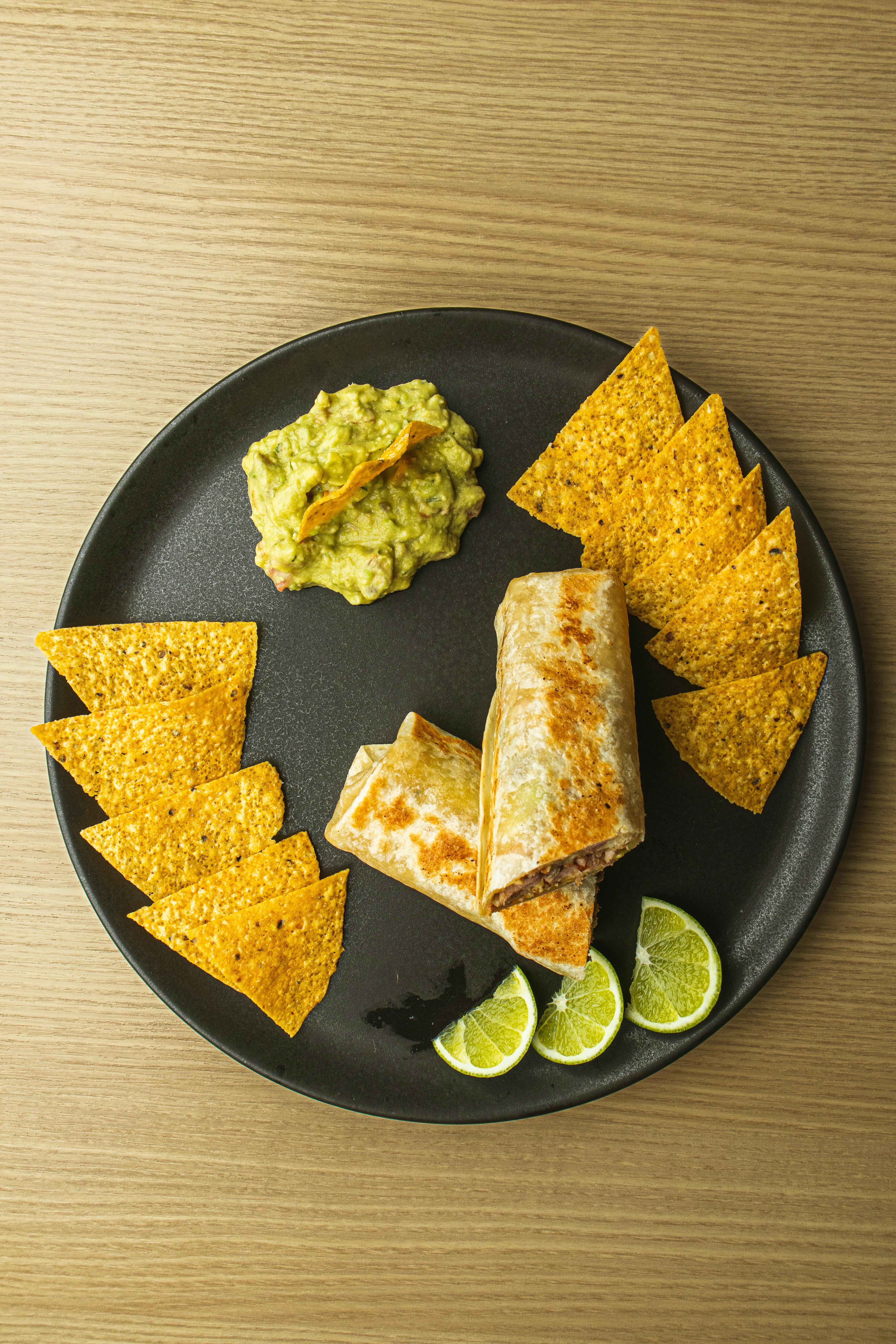 delicious mexican burrito with guacamole and tacos