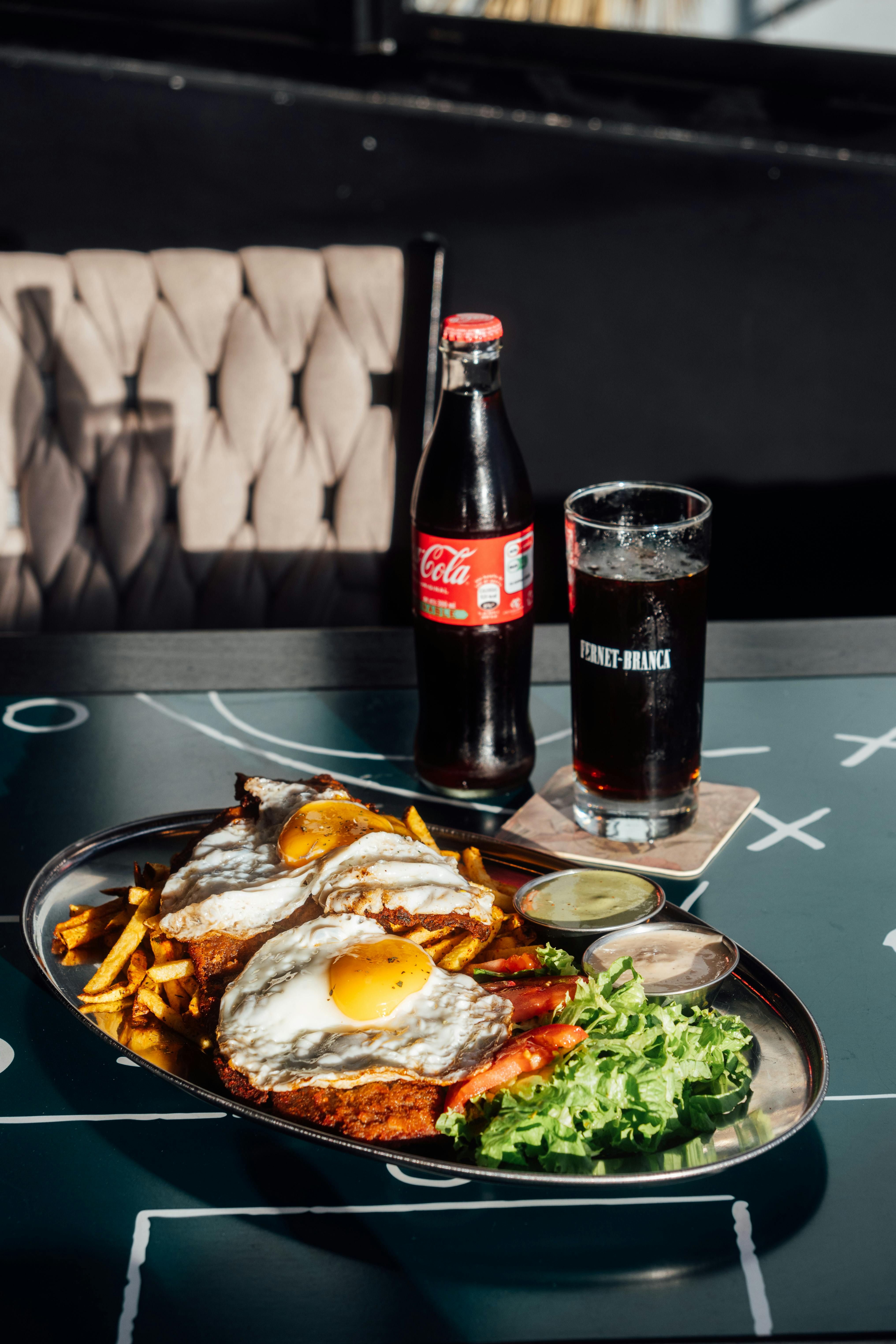 gourmet platter with fried eggs and soda