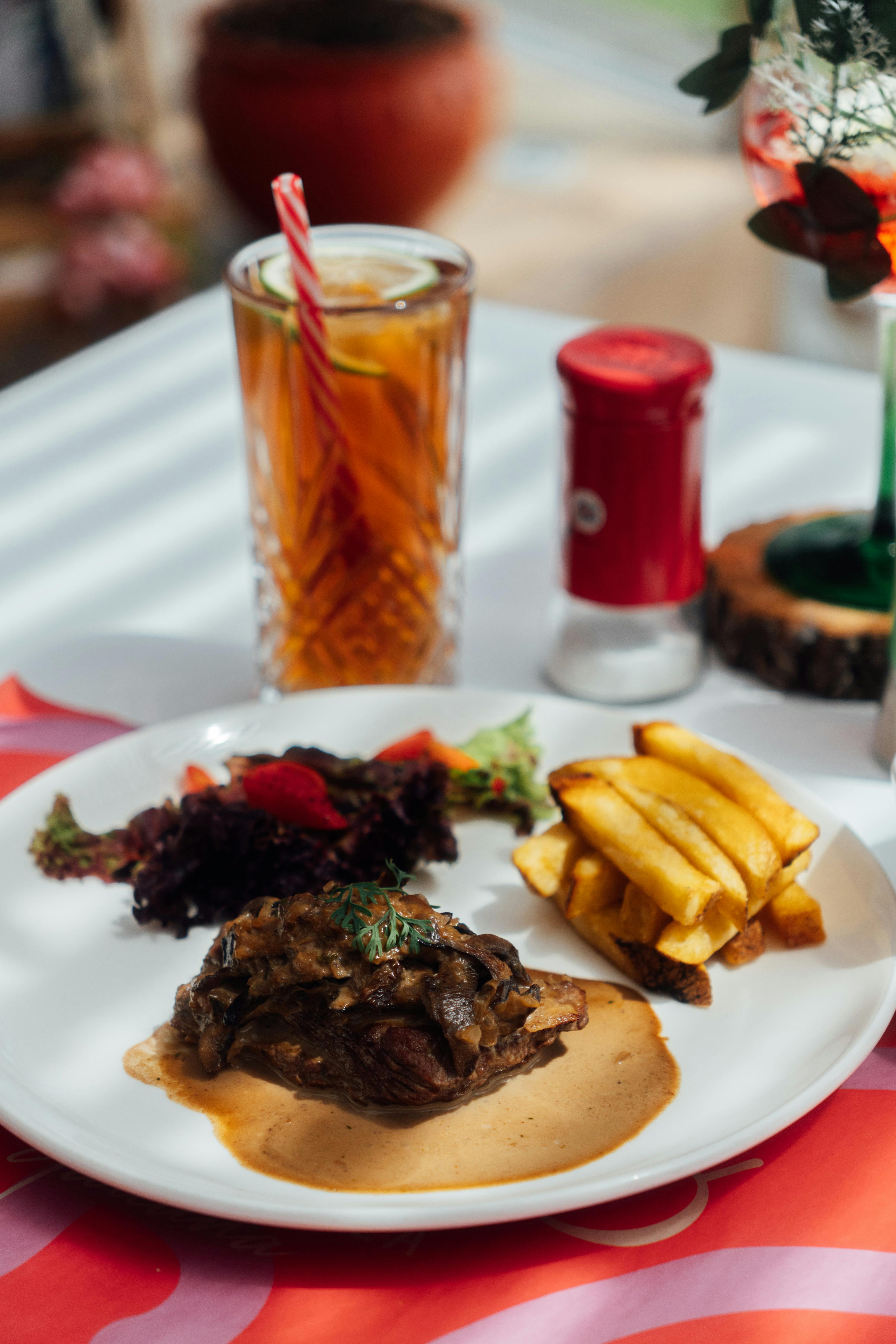 gourmet steak meal with fries and iced tea