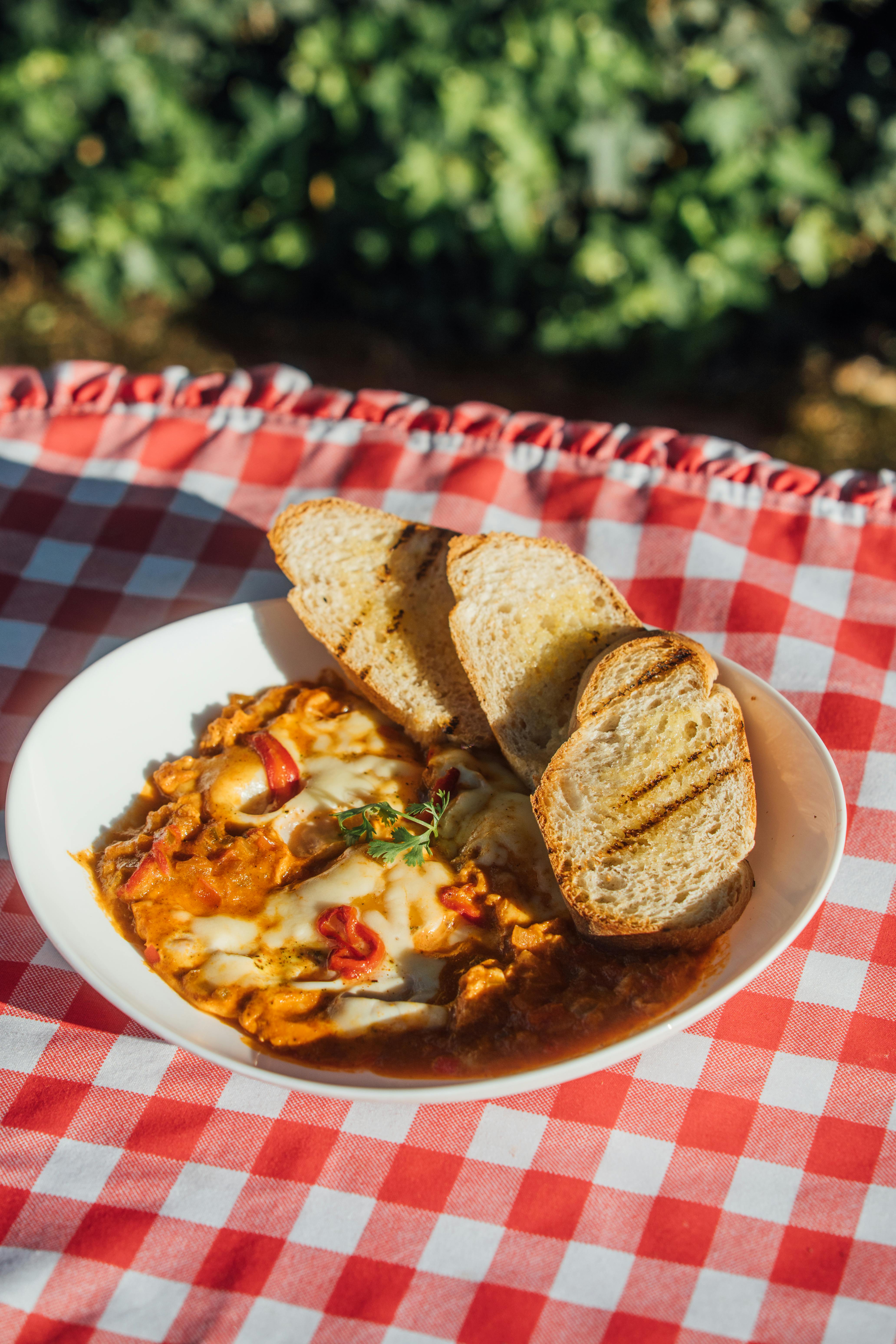 delicious shakshuka dish with grilled bread