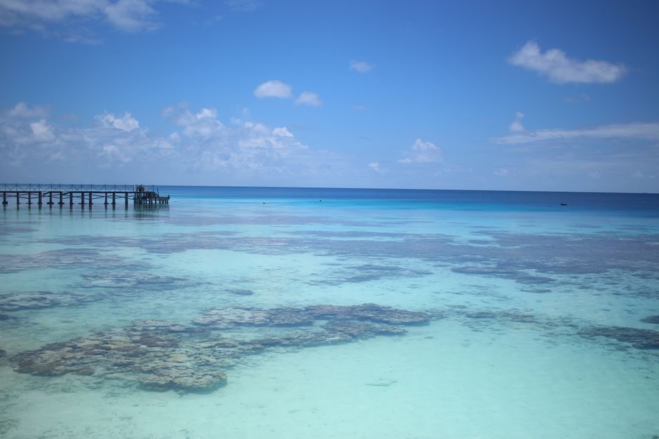 Beautiful clear waters near a wooden pier in Tuamotu, French Polynesia.