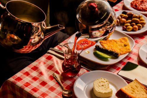 Free Experience a cozy Turkish breakfast in Bursa with tea, cheese, olives, and more. Stock Photo