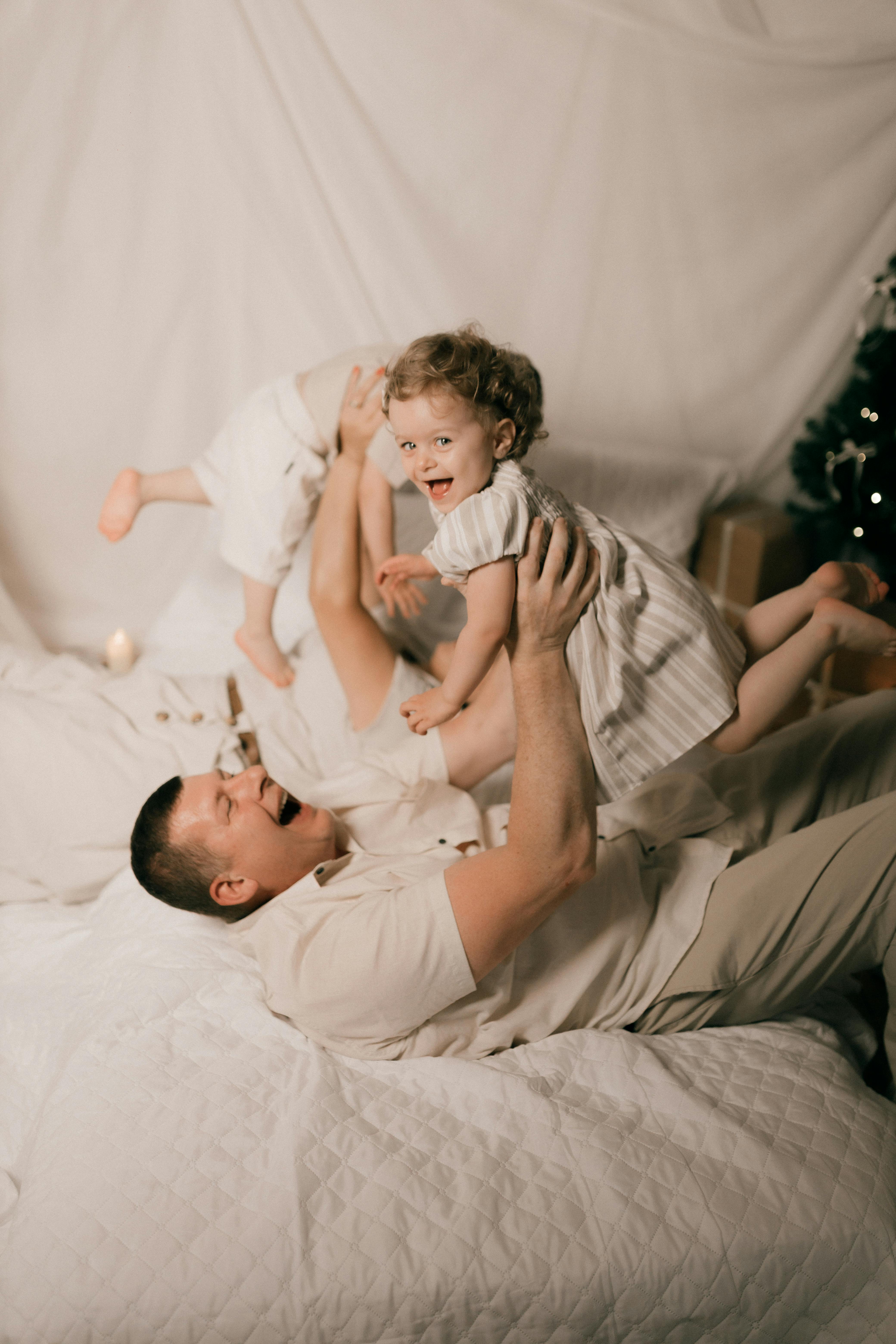 Happy family enjoying playful moments indoors with cheerful laughter.