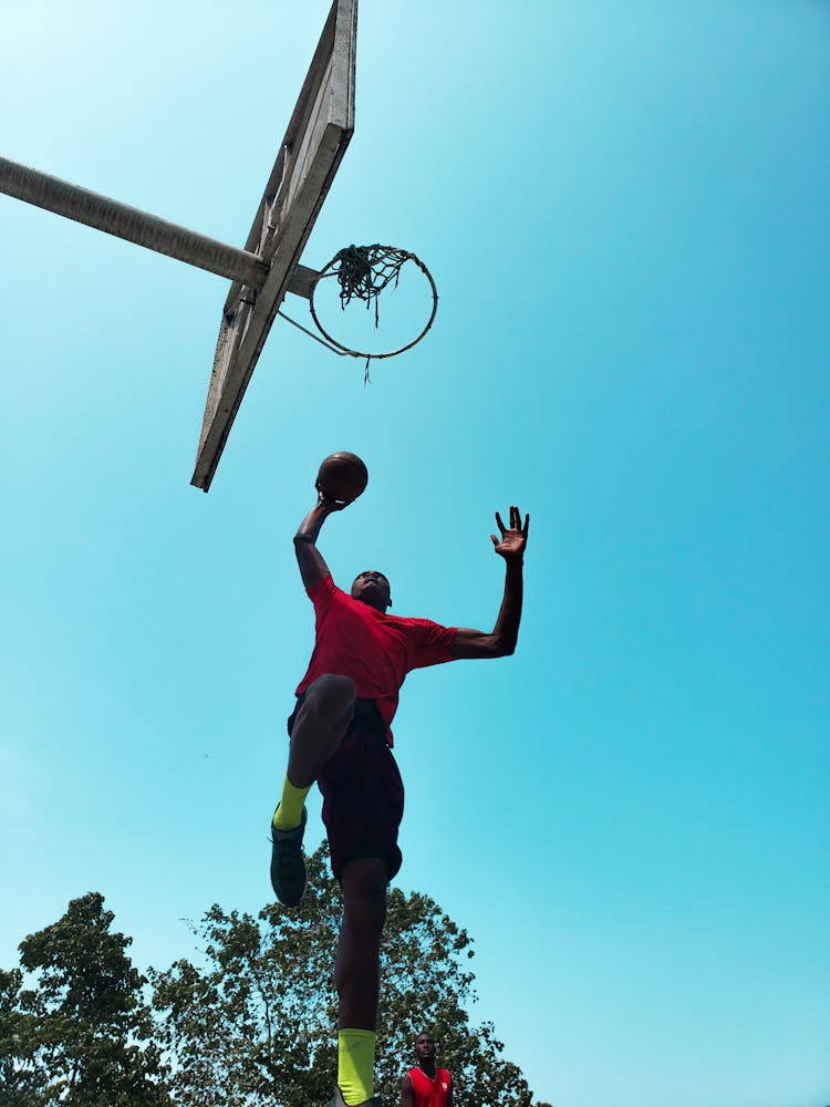 Low Angle Photo Of Man Playing Basketball