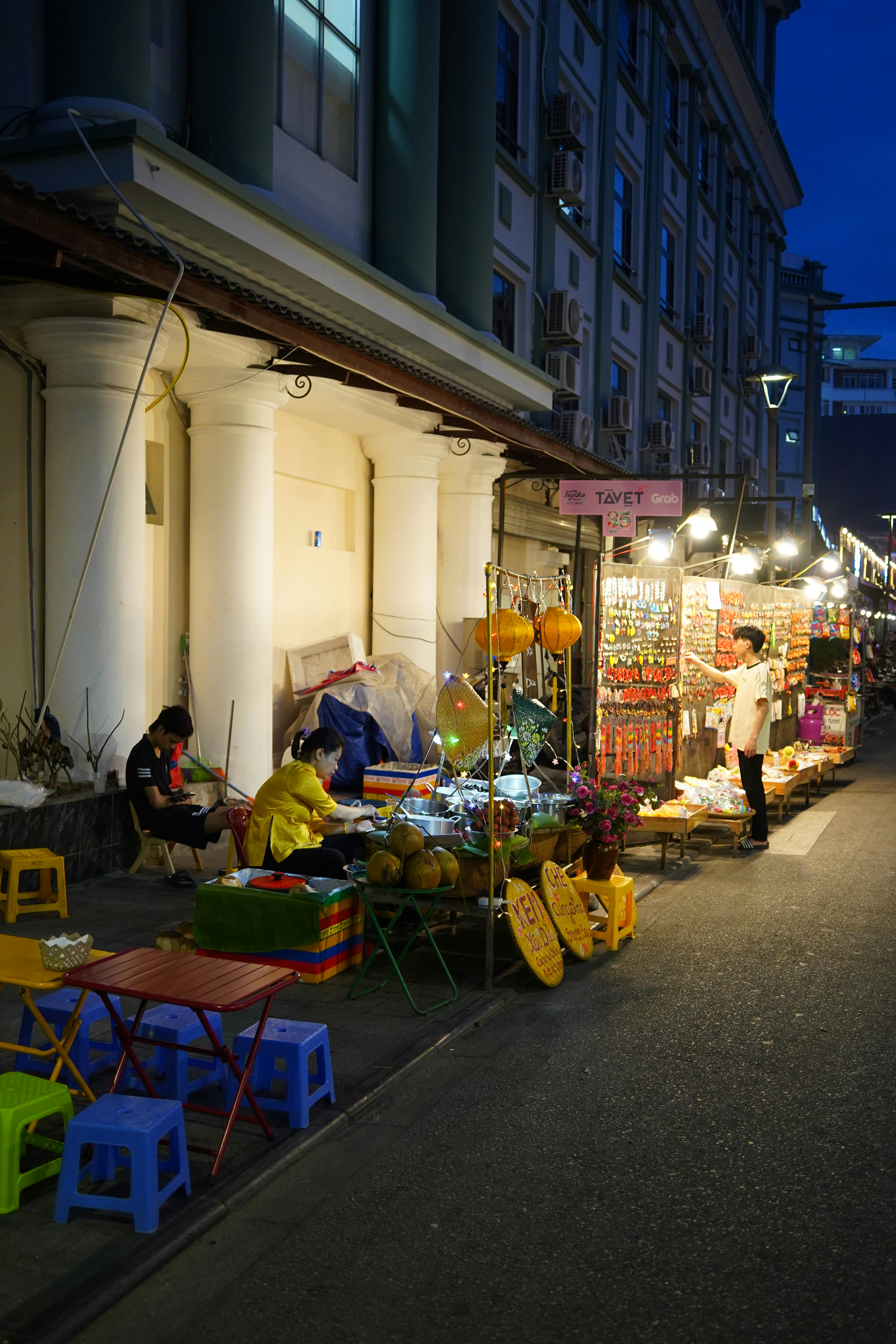 Outdoor dining tables and charcoal satay grills along Boon Tat Street Satay Street at night beside Lau Pa Sat in Singapore's CBD