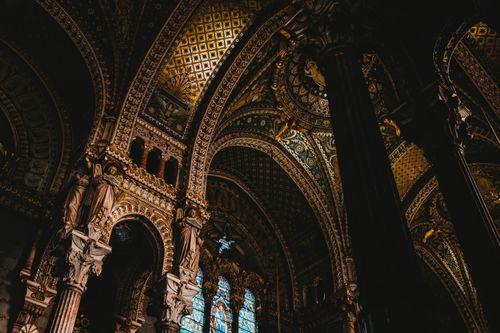 Free A stunning low angle view of ornate baroque cathedral ceiling with detailed architecture and stained glass windows. Stock Photo
