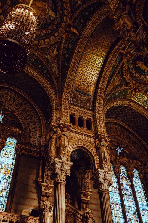 Free Intricately detailed cathedral interior with ornate arches and vibrant stained glass windows. Stock Photo