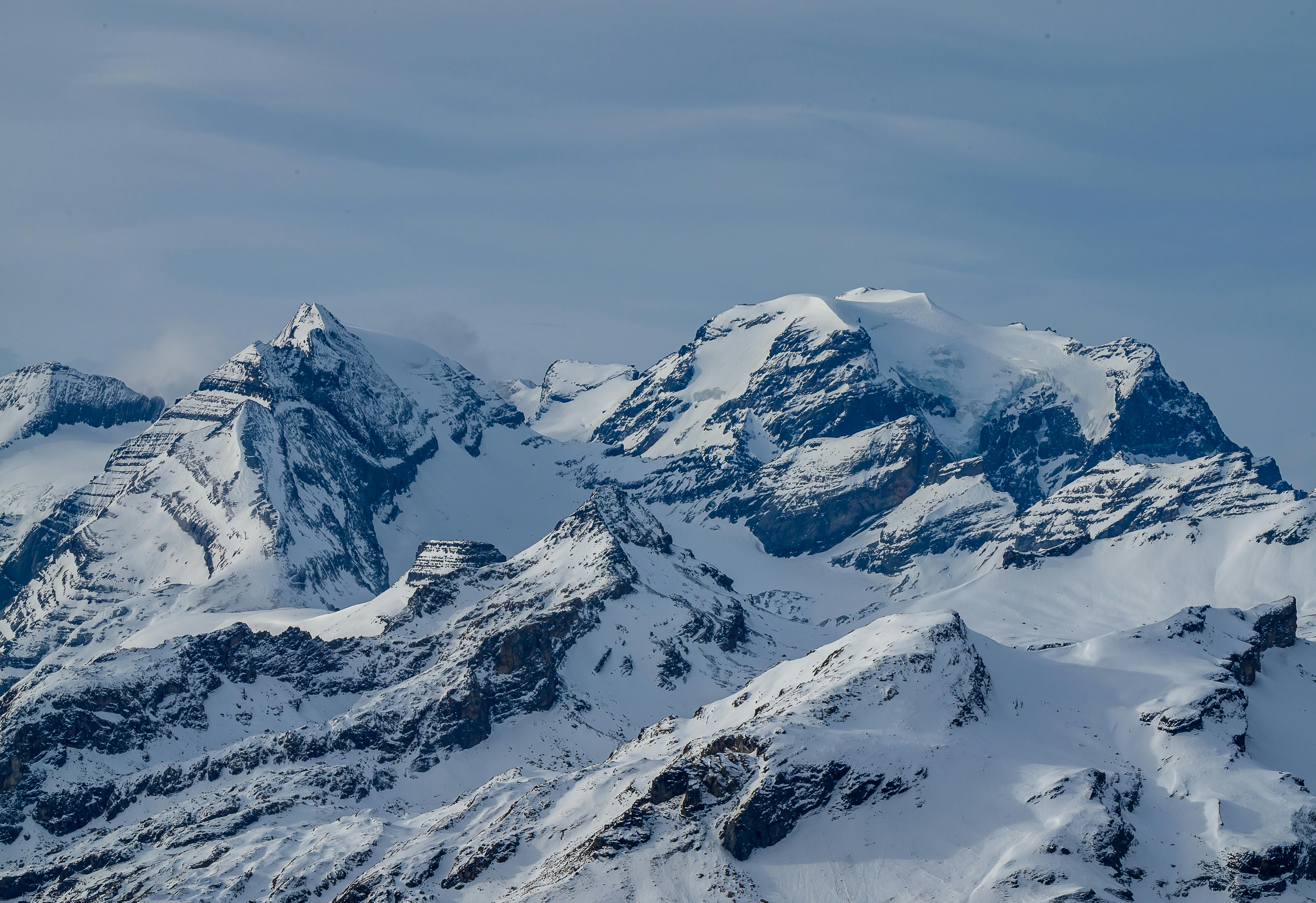 Breathtaking view of snow-covered peaks in the Swiss Alps, showcasing the majestic Glarus Süd landscape.