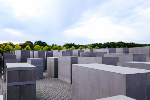 Free Depicts the geometric concrete blocks of the Holocaust Memorial outdoors under a cloudy sky. Stock Photo