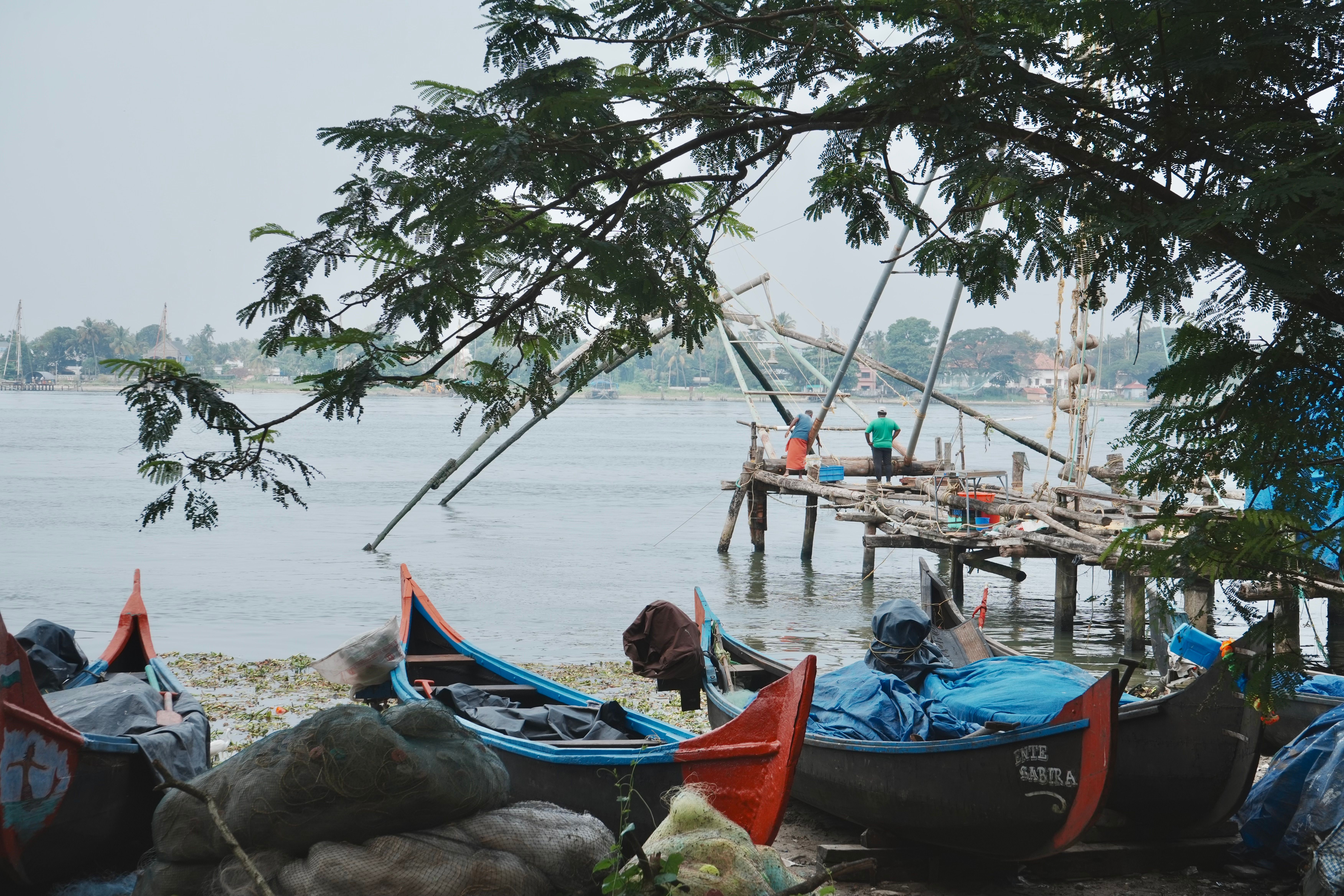Chinese fishing nets silhouetted against the sunset at Fort Kochi beach