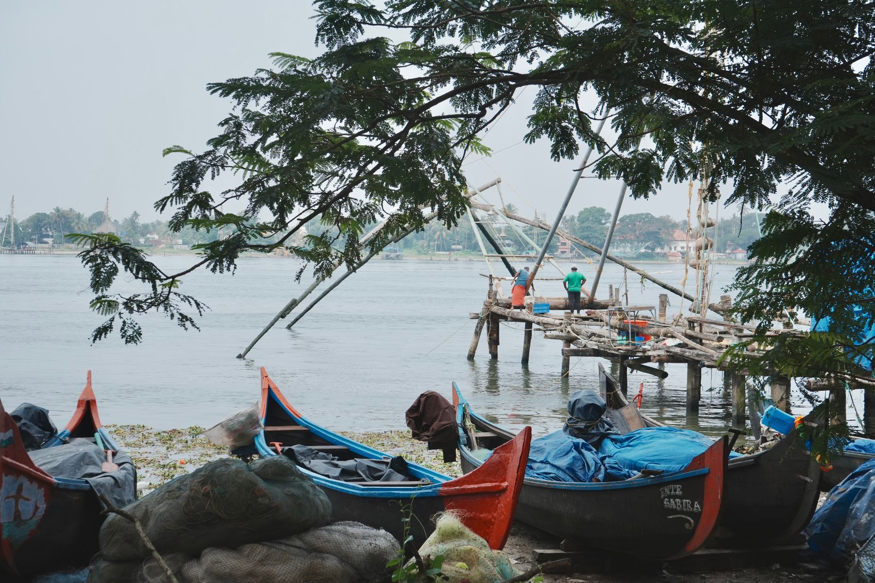 Waterfront view across Kochi harbour toward the historic Fort Kochi peninsula at dusk