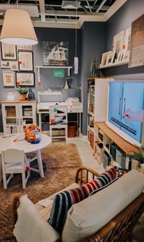 Stylishly decorated living room with modern furniture and wall art, creating a cozy atmosphere.