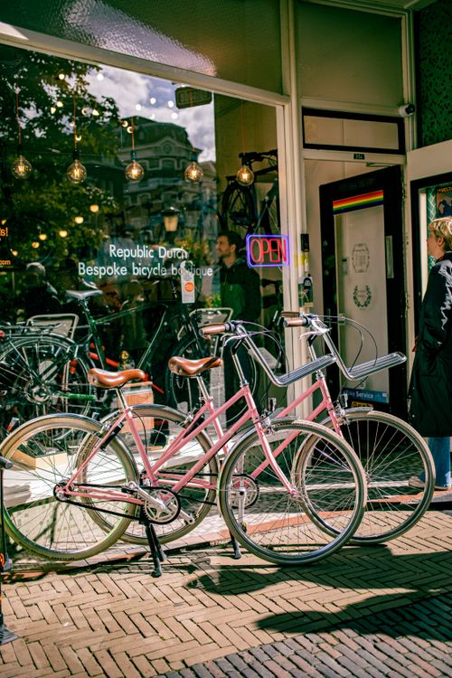 Free A bicycle boutique with pink bikes displayed outside in the vibrant streets of Utrecht. Stock Photo