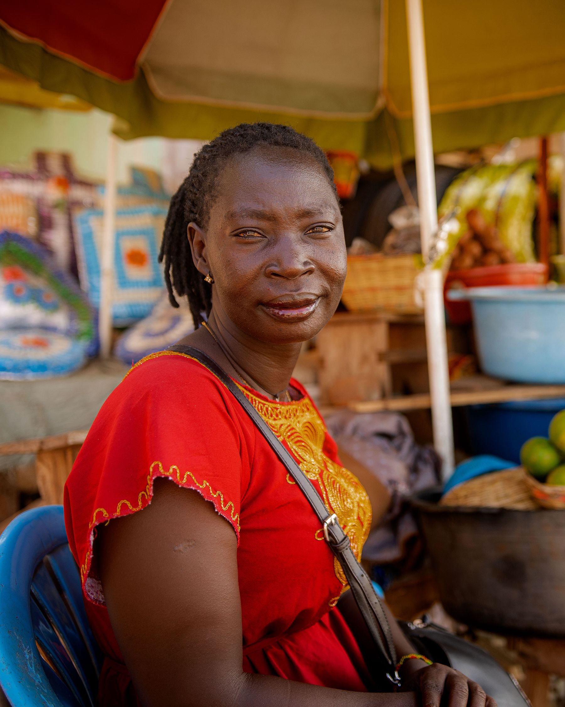 Busy African open-air market with fruit stalls and people walking