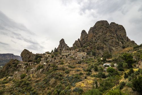 Free Explore a stunning ancient village nestled in rocky mountains with lush greenery. Stock Photo