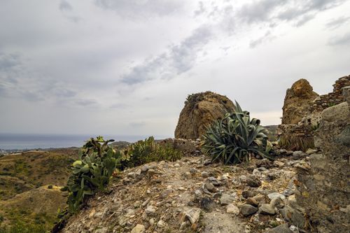 Free Stunning view of ancient ruins on a rocky Mediterranean landscape with vegetation. Stock Photo