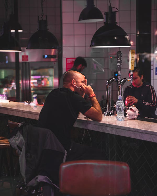 Man Sitting Inside Bar