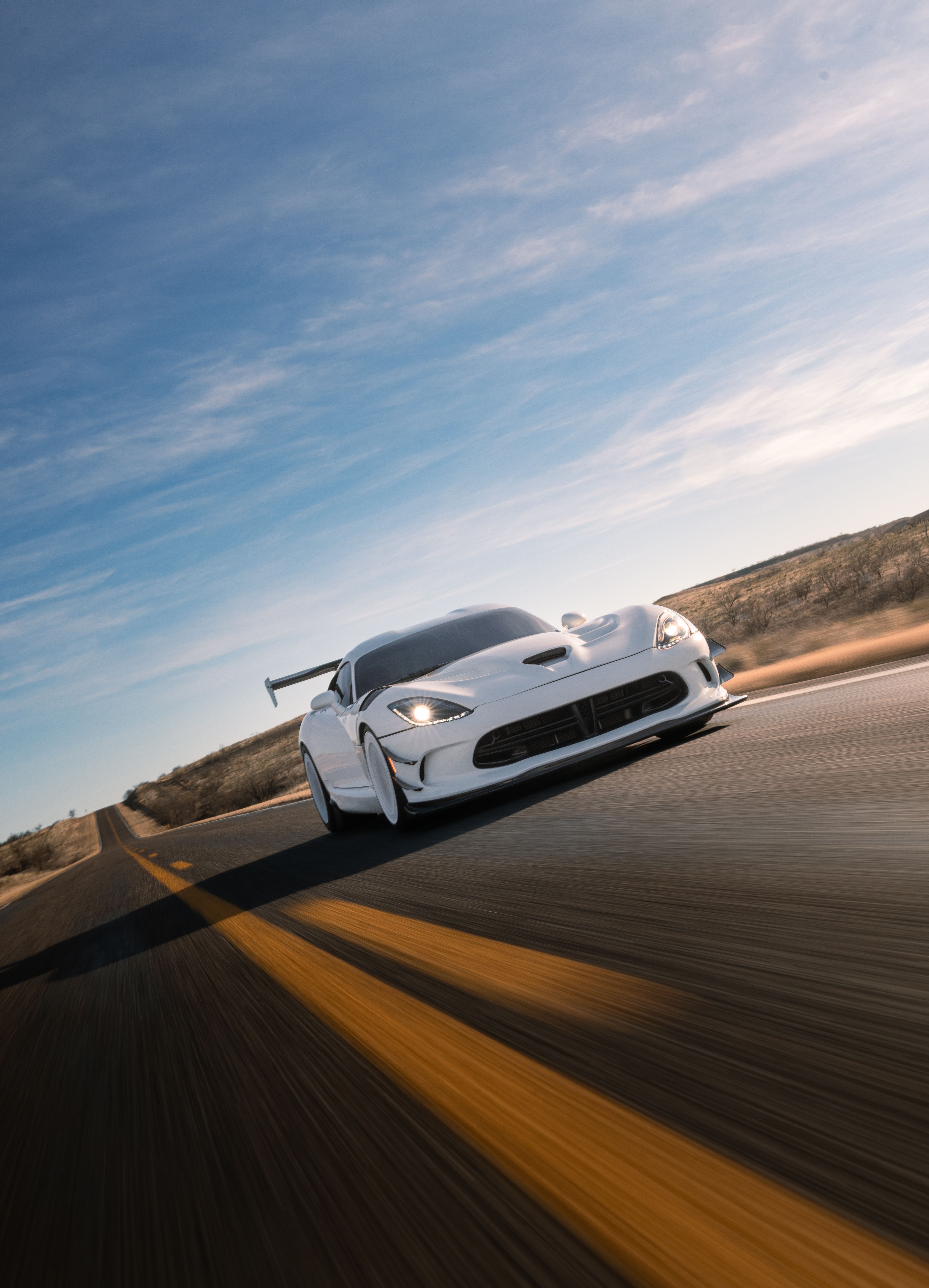 Sleek Sports Car Racing on Desert Highway · Free Stock Photo